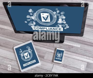 Compliance concept shown on different information technology devices Stock Photo