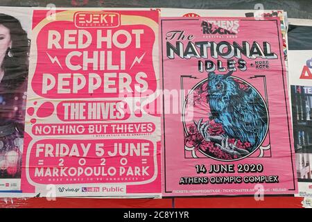 Athens, Greece - June 7, 2020: Red Hot Chili Peppers and The National concert posters on city wall. Live music events canceled due to coronavirus. Stock Photo