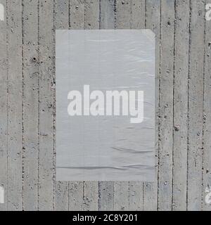 White crumpled paper wheatpaste poster on concrete wall background. Design element. Stock Photo