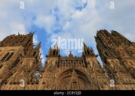 Gothic facade of the Cathédrale Notre-Dame de Rouen (Rouen Cathedral) in France's Normandy lit by the warm dawn light Stock Photo