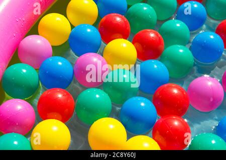 Colorful balls in the swimming pool, summer concept Stock Photo