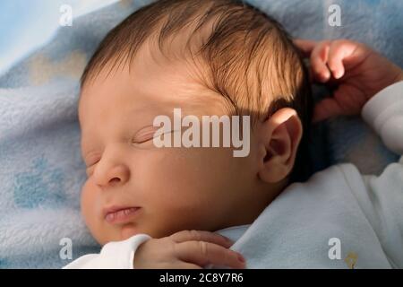 Close-up of newborn sleeping peacefully Stock Photo