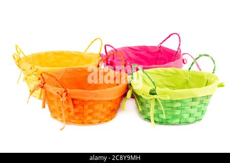 Four colorful empty wicker baskets isolated on white background. Stock Photo