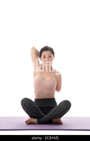 Sitting cross-legged on yoga, middle-aged lady Stock Photo