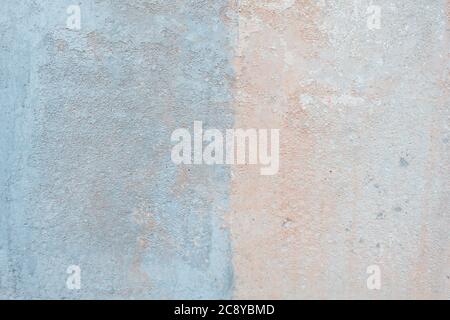 Colored pale concrete wall texture. Stucco painted in baby blue and peach colors Stock Photo