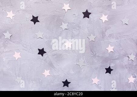 Paper confetti stars on gray background Stock Photo