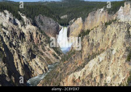 Spring in Yellowstone National Park: Faint Rainbow at the Base of the Lower Falls in the Grand Canyon of the Yellowstone River Seen From Artist Point Stock Photo