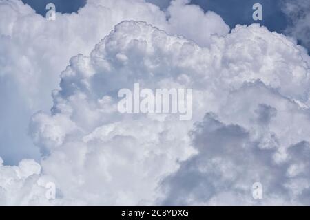 Towering Cumulus clouds forming in the sky before the onset of a thunderstorm in a tropical climate. Stock Photo