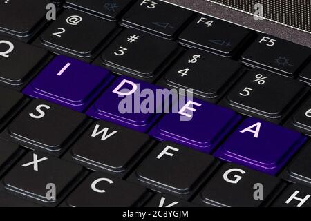 Computer keyboard with text IDEA on the keys and color accent. Concept of start-up business and  success. Closeup view Stock Photo