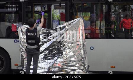 Bonn, Germany. 27th July, 2020. A member of the criminal investigation department photographs the scene of a knife attack in a public bus. A 55-year-old man is said to have stabbed another passenger on Monday in a public bus near Bonn's central station. The police arrested the suspect. (to dpa 'Knife attack in Bonn public bus - 55-year-old man arrested') Credit: Thomas Kraus/dpa/Alamy Live News Stock Photo