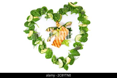 Heart Shape green Detox Salad and Vegetables with Grilled Salmon isolated on white Background Stock Photo