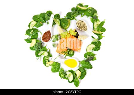 Heart Shape green Detox Salad and Vegetables with raw Salmon isolated on white Background Stock Photo