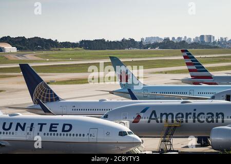 Vertical Stabilizers from major airliners parked in the remote area of Guarulhos Intl. Airport. Planes awaits there while serviced by ground handling. Stock Photo