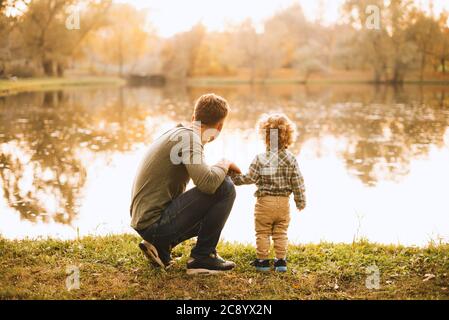Photo of father and son having time together in park during autumn Stock Photo