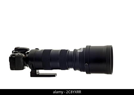 Horizontal shot of a super telephone zoom lens on a digital camera isolated on white. It is a side shot. Copy space. Stock Photo