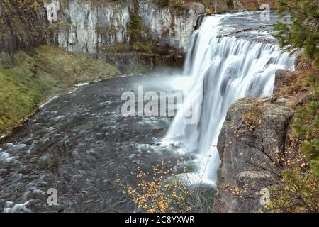 Water flows over Upper Mesa Falls in autumn, on the Henry's fork of the Snake River in Eastern Idaho. Stock Photo