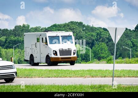 Horizontal shot of an unmarked armored car in traffic. Stock Photo