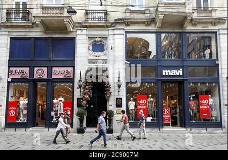 Istanbul, Turkey. 27th July, 2020. People walk past stores in Istanbul, Turkey, on July 27, 2020. The Turkish economy took an uphill climb with hikes in inflation in June when the government decided to ease the lockdown restrictions imposed to curb the spread of coronavirus. Credit: Osman Orsal/Xinhua/Alamy Live News Stock Photo