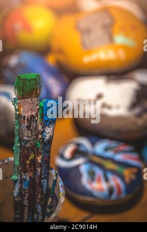 Used paintbrushes with dried paint left standing in a cup Stock Photo