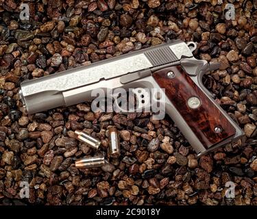 A nickle plated Colt 45 Mark IV 80 serries with custom engraving on the barrel. Stock Photo