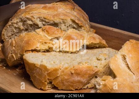Homemade wholegrain rye bread, cut slices into pieces and pieces, on wooden cutting Board. Stock Photo