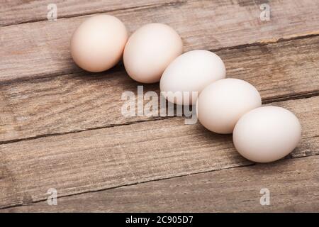 The eggs, the top view which are laid out in a row on a wooden table from old boards, nobody. Stock Photo