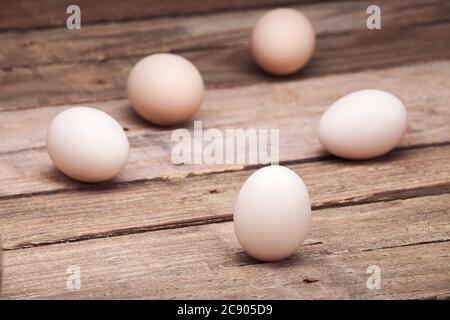 The eggs scattered on a wooden table from old boards, nobody. Stock Photo