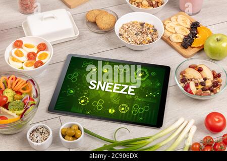 Healthy Tablet Pc compostion with SNEEZE inscription, immune system boost concept Stock Photo