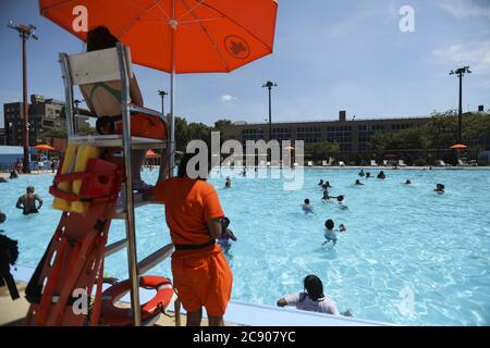 New York, USA. 27th July, 2020. Lifeguards are seen on duty by a swimming pool in New York, the United States, on July 27, 2020. A heat wave hit New York City on Monday as the highest temperature reached over 36 degrees Celsius. Credit: Wang Ying/Xinhua/Alamy Live News Stock Photo