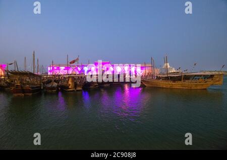 Doha: Dhow harbor and Museum of Islamic Art at twilight. Qatar Stock Photo