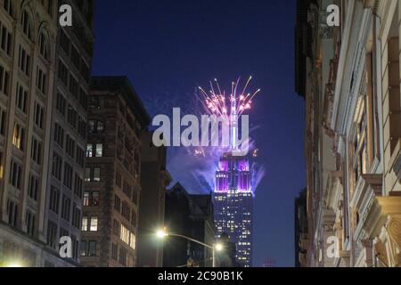 Empire State Building with Blue Fireworks at Night, view from Lower Fifth Avenue, New York City, New York, USA
