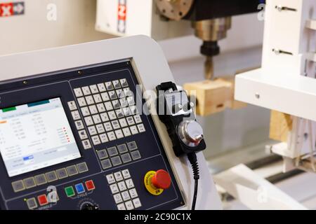 Control panel with pendant handheld controller of CNC woodworking machine. Selective focus. Stock Photo