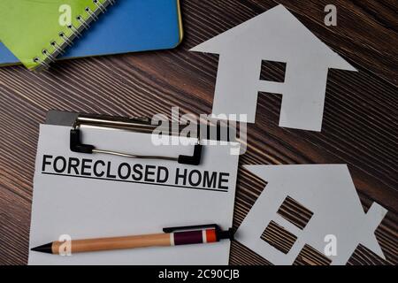 Foreclosed Home text write on paperwork isolated on office desk. Stock Photo