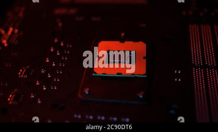 A CPU processor computer concept on motherboard in red lights Stock Photo