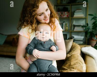 Mother holding baby boy (6-11 months) Stock Photo