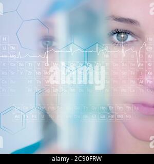 Woman looking at periodic table Stock Photo