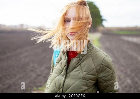 Russia, Omsk, Portrait of young woman in field Stock Photo