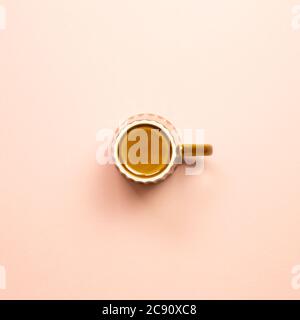 Brown empty mug cup on pink background. top view Stock Photo