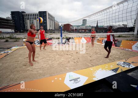 Team England players play beach volleyball during a demonstration at Smithfield, Birmingham City Centre. The Birmingham 2022 basketball and beach volleyball competitions will take place in the city centre location of Smithfield, Smithfield is the site of the former Birmingham Wholesale Market, which was cleared in 2018 and is the focus of a major regeneration plan. Stock Photo