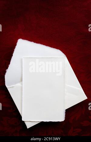 Vintage blank writing paper and envelope, top view over rich rerd background Stock Photo