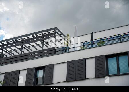 Modern architecture in the city with roof terrace and cloudy sky Stock Photo
