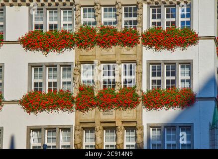 Traditional building with flowers on the balcony in Munich, Germany Stock Photo