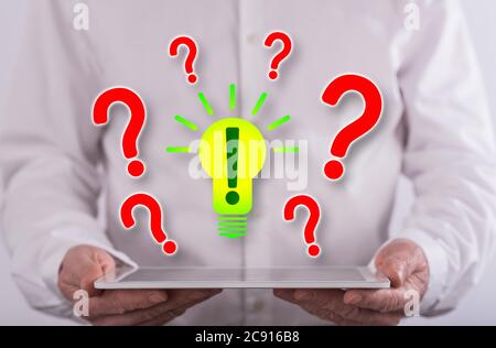 Problem solving concept above a tablet held by a man in background Stock Photo