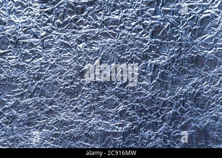 Crumpled wrinkled blue metallic foil texture Stock Photo