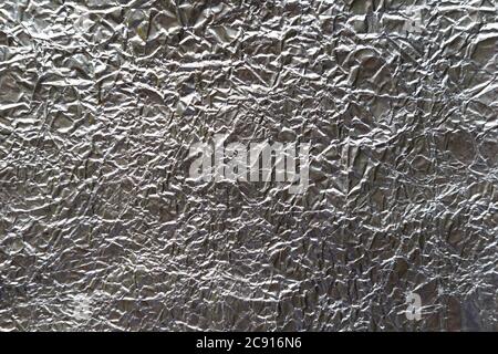Crumpled wrinkled silver foil texture Stock Photo