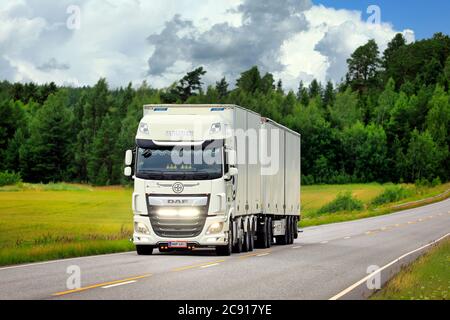 White DAF XF freight transport truck Malinen with bright LED lights on the road on a day of summer. Salo, Finland. July 24, 2020. Stock Photo