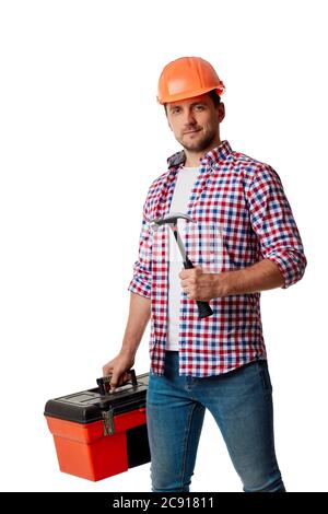 Young caucasian builder worker in yellow hard hat and shirt holding hammer and tool box. handyman wearing tool belt isolated on white studio background Stock Photo