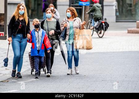 Antwerp, Belgium. 27th July, 2020. People wearing face masks as a preventive measure walk on the street during the coronavirus crisis.The wearing of a face mask will become compulsory from Saturday in shops and some other indoor spaces where people gather. Credit: SOPA Images Limited/Alamy Live News Stock Photo