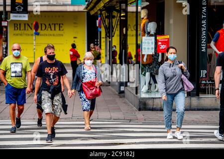 Antwerp, Belgium. 27th July, 2020. People wearing face masks as a preventive measure walk on the street during the coronavirus crisis.The wearing of a face mask will become compulsory from Saturday in shops and some other indoor spaces where people gather. Credit: SOPA Images Limited/Alamy Live News Stock Photo