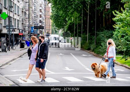 Antwerp, Belgium. 27th July, 2020. People wearing face masks as a preventive measure walk on the street during the coronavirus crisis.The wearing of a face mask will become compulsory from Saturday in shops and some other indoor spaces where people gather. Credit: SOPA Images Limited/Alamy Live News Stock Photo